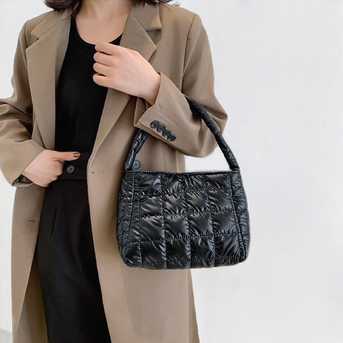 Model carrying a black polyester bag handheld, easy for commuting and weekends.