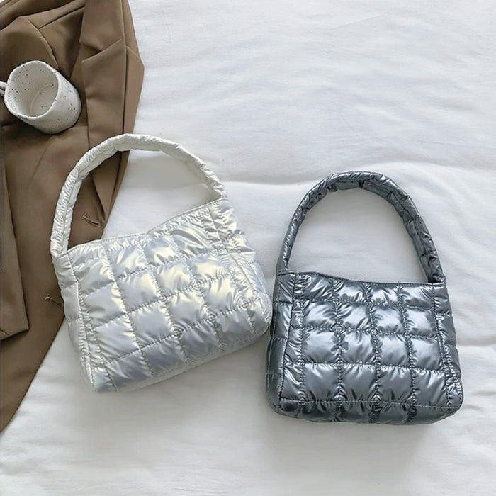 Folded view of Metallic Glow Quilted Bag in white and gray, easy for commuting and weekends.