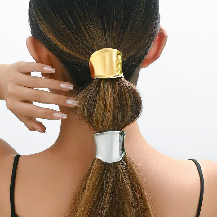 Model wearing two colors of Metallic Wave Hair Cuff on ponytail, one gold and one silver.