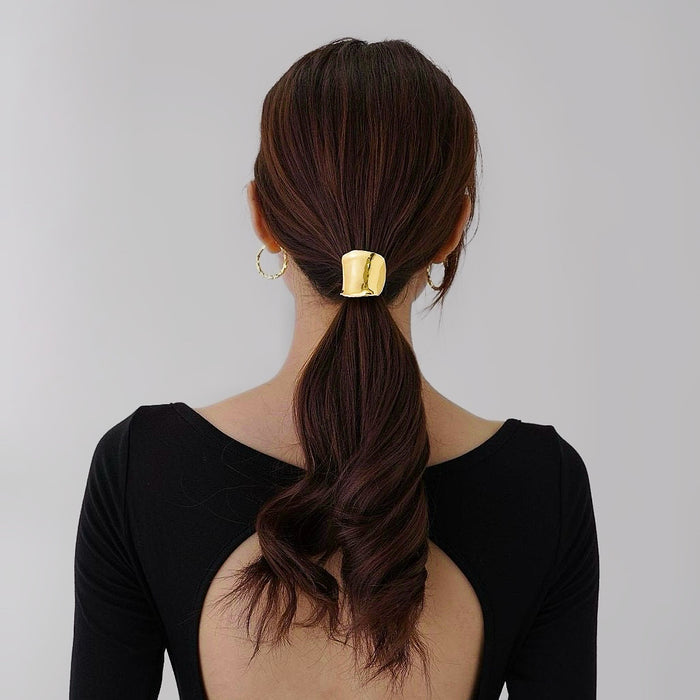 Model wearing a gold Metallic Wave Hair Cuff, great for everyday styling and gifting.