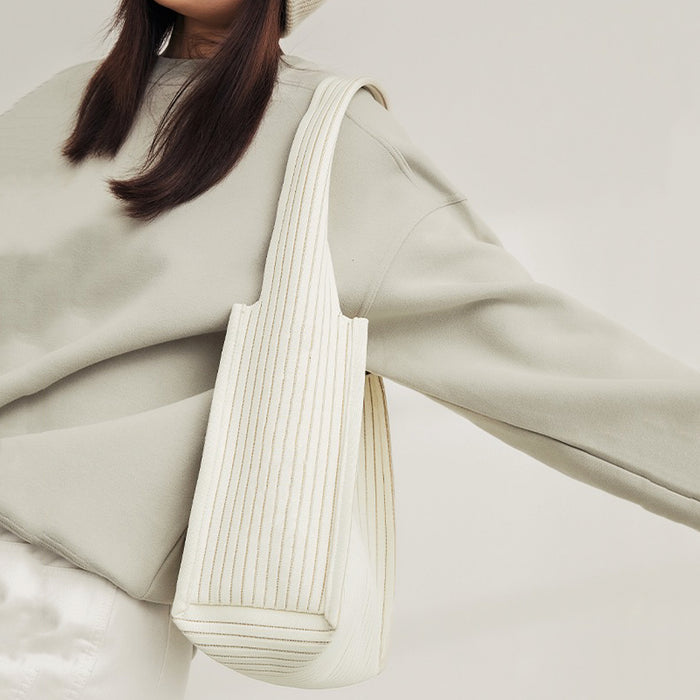 Model carrying a  white Milk Carton Textured Woven Tote Bag on shoulder, easy for commuting and weekends.