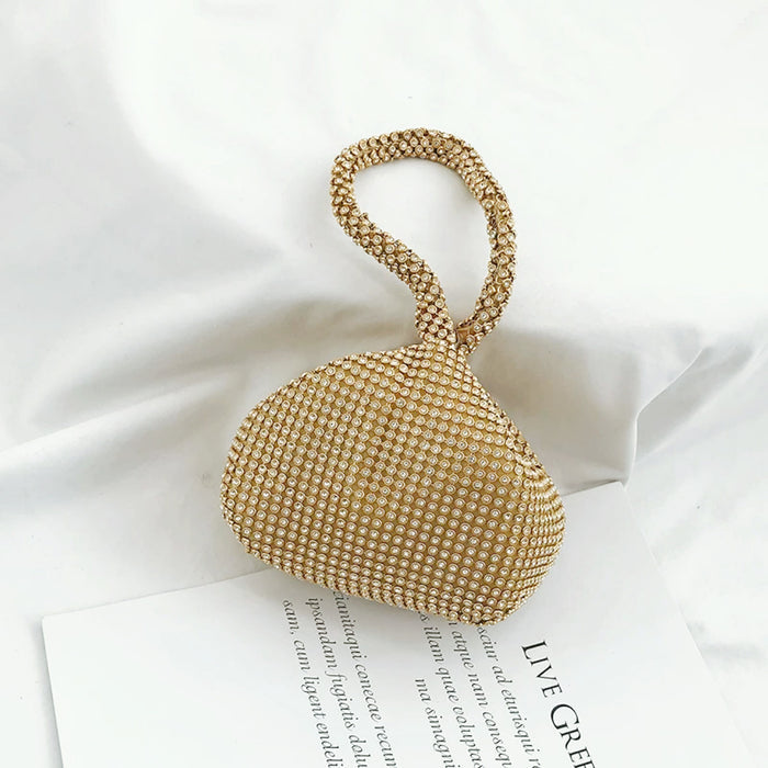 Close-up of Gold rhinestone mini diamond party handbag with a braided handle.