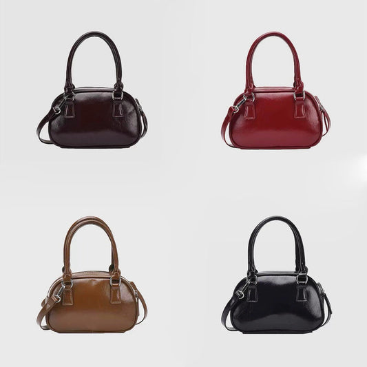 Front view of Four mini PU leather bowling bags in brown, red, tan, and black, with grab handles and detachable.