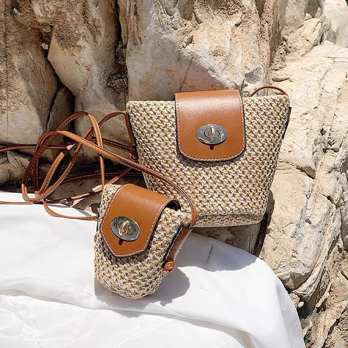 Front view of Two mini PU mix raffia straw bucket crossbody bags, one large and one small.