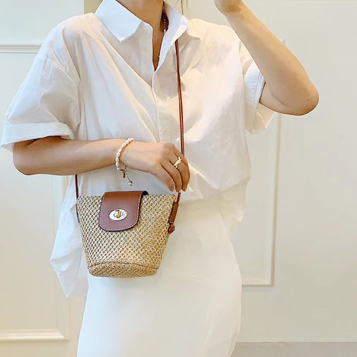 Model carrying a middle size of Raffia Straw Bucket Crossbody Bag, great for daily carry.