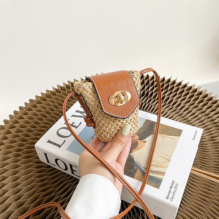 Model holding a small  size of Mini raffia straw bucket crossbody bag, easy for commuting and weekends.