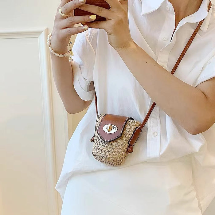 Model wearing a small size of Raffia Straw Bucket Crossbody Bag, ideal for errands and gifting.