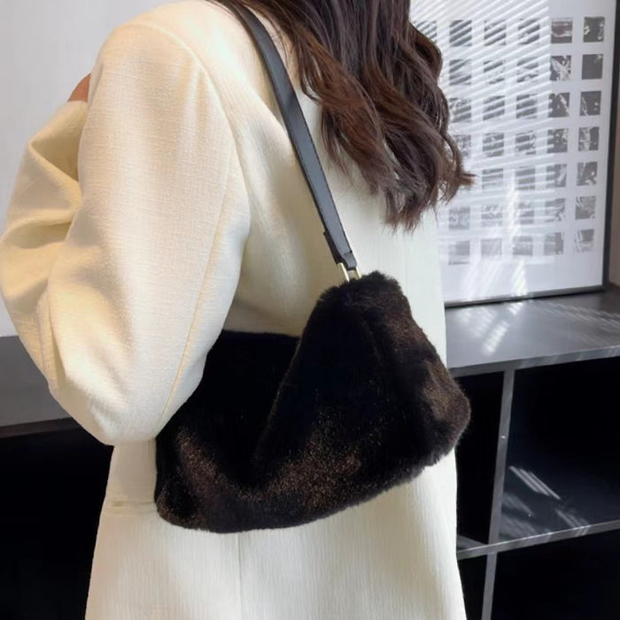 Model carrying a black mini fluffy shearling baguette bag on the shoulder, great for daily carry and travel.