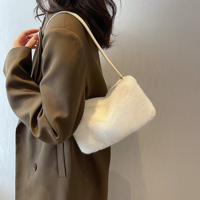 Model carrying a white mini fluffy shearling baguette bag on the shoulder, ideal for city walks and gifting.