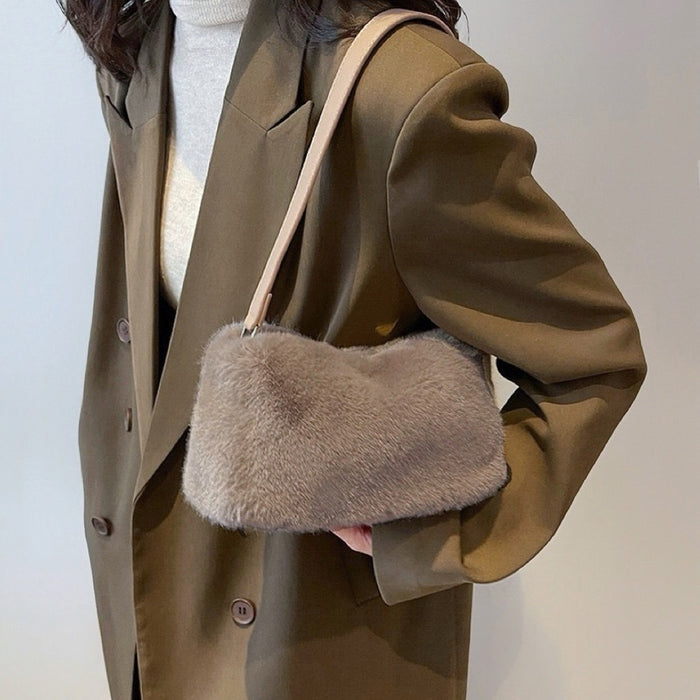 Model carrying a khaki mini fluffy shearling baguette bag  on the shoulder, easy for commuting and weekends.