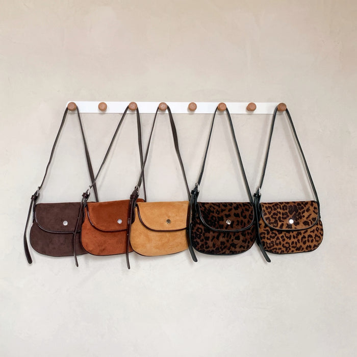 Collection of mini suede saddle bags in various colors including leopard print and tan, brown ,khaki.