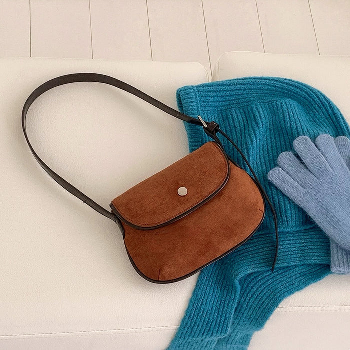 Solid tan color version of the mini suede saddle bag with a hat and gloves.