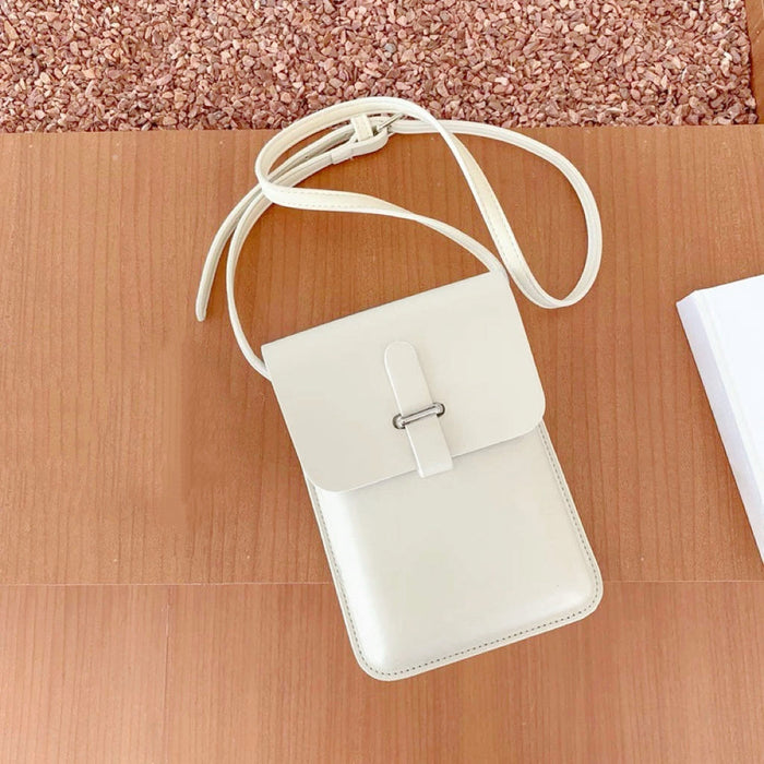 Close-up of Minimalist off-white PU leather crossbody bag with loop-through closure and long strap