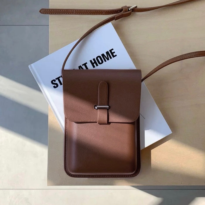 Angled view of Minimalist Rigid Leather Bag in brown, great for everyday carry and travel.