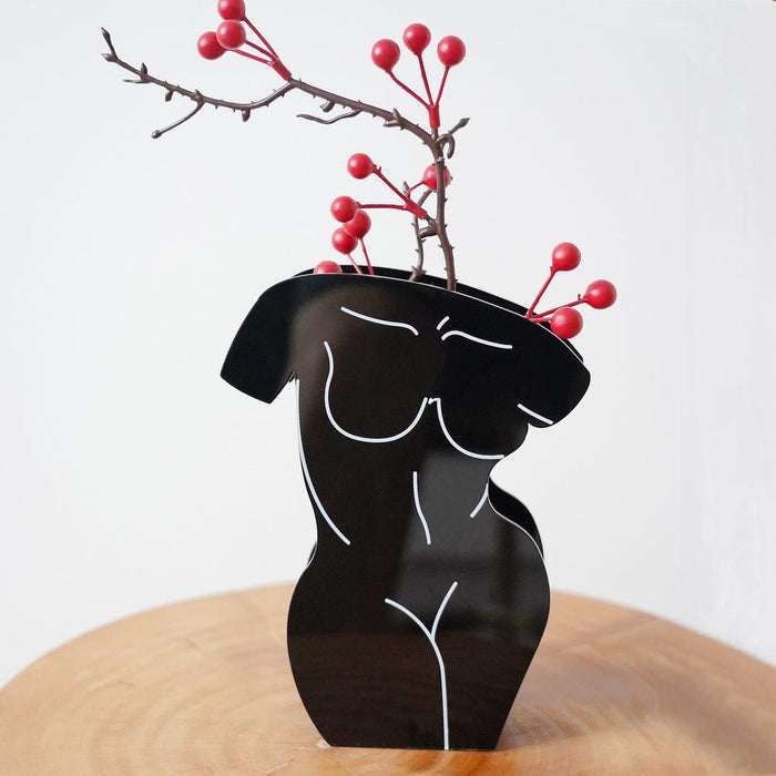 Angled view of Modern Black Body shoped Vase with berry branch, great for home decor and gifting