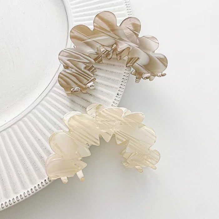 Grey and white Moon Hair Claws shown together, ideal for quick updos and ponytails.