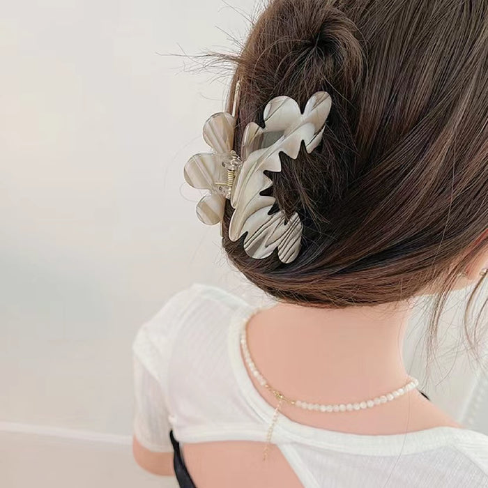 Model wearing Moon Hair Claw hair claw clip in gray, easy for workdays and special occasions.