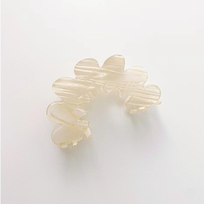 Flat lay of Moon Hair Claw in white, great for everyday styling and gifting.