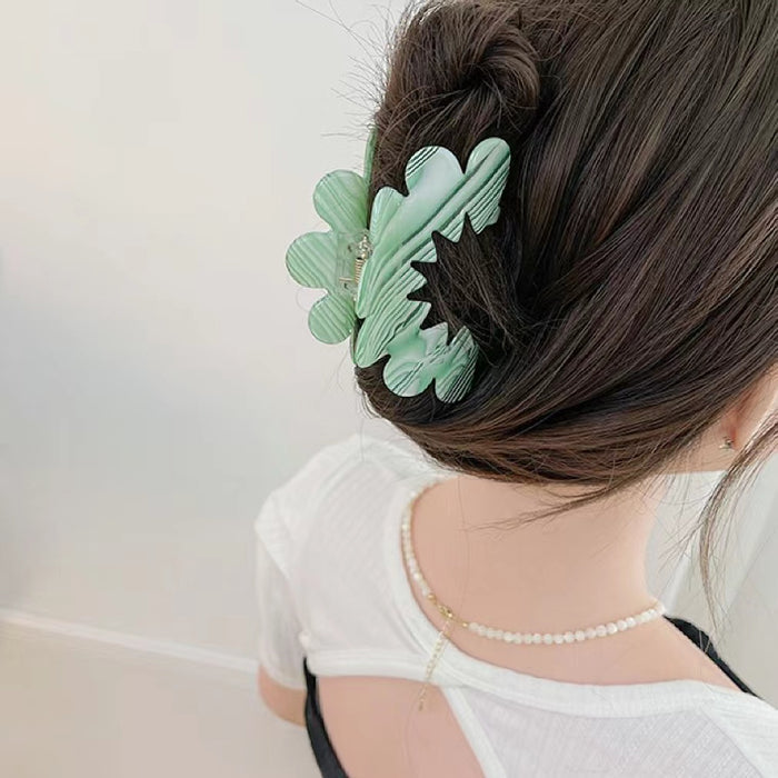 Model wearing Moon Hair Claw in green, ideal for quick updos and ponytails.