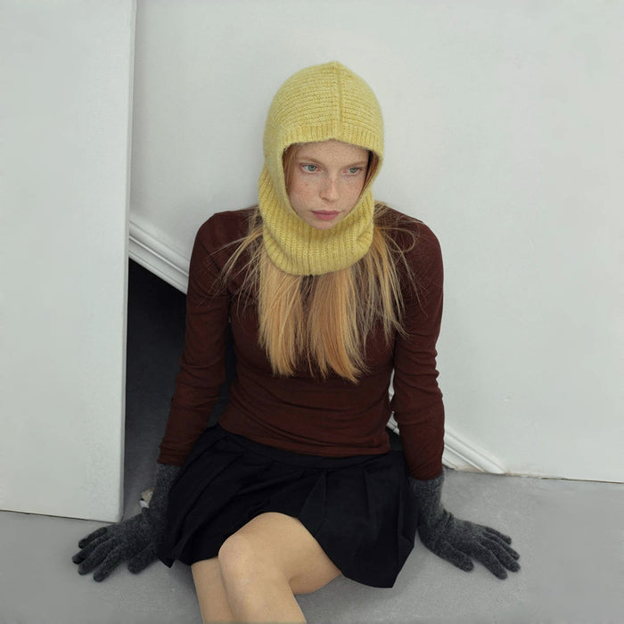 Model wearing cream yellow Morandi Toned Knit Balaclava Hat, features a gentle hue in a protective wool build.