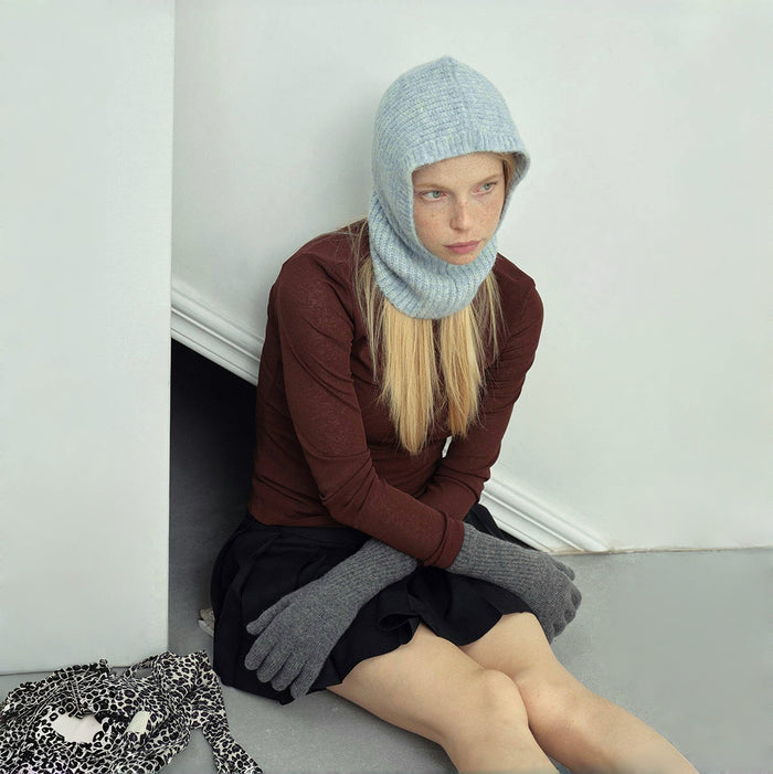 Model wearing pale blue Morandi Toned Knit Balaclava Hat, features a serene aesthetic in high-quality wool.