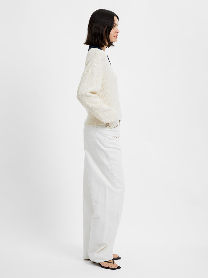 Person wearing a white outfit on a plain background