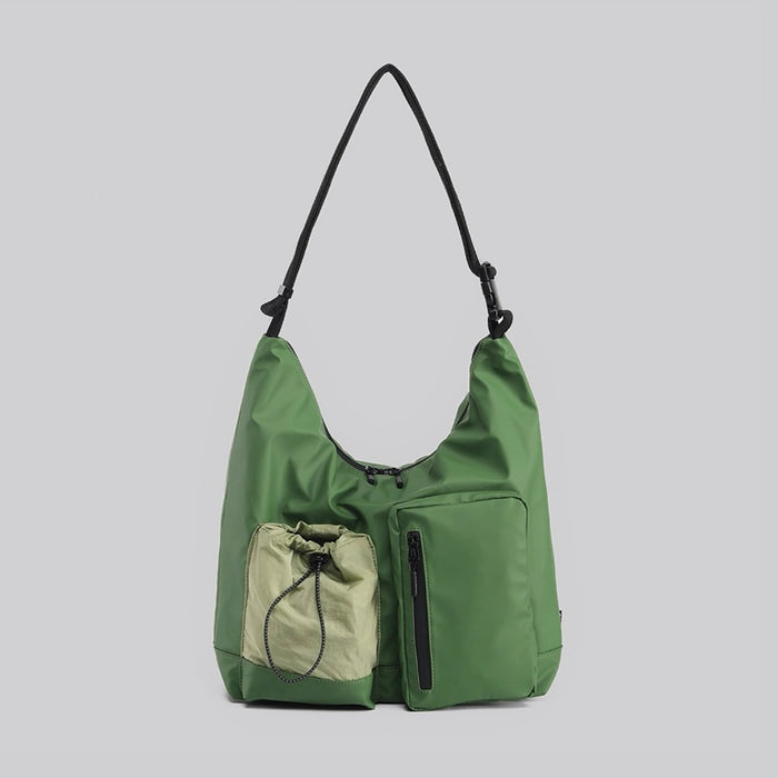 Green Gorpcore-style crossbody bag featuring multiple utility pockets and adjustable strap.