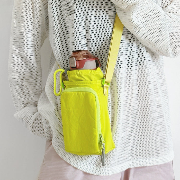 A model styling a neon yellow hydration pouch for hiking, emphasizing visibility and water-resistant nylon fabric.