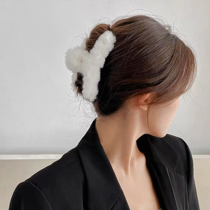 Model wearing a white Plush Hair Claw, ideal for quick updos and ponytails.