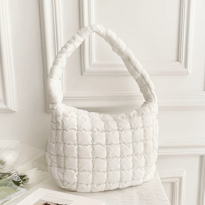 Front view of white puffy shoulder bag on a clean background.