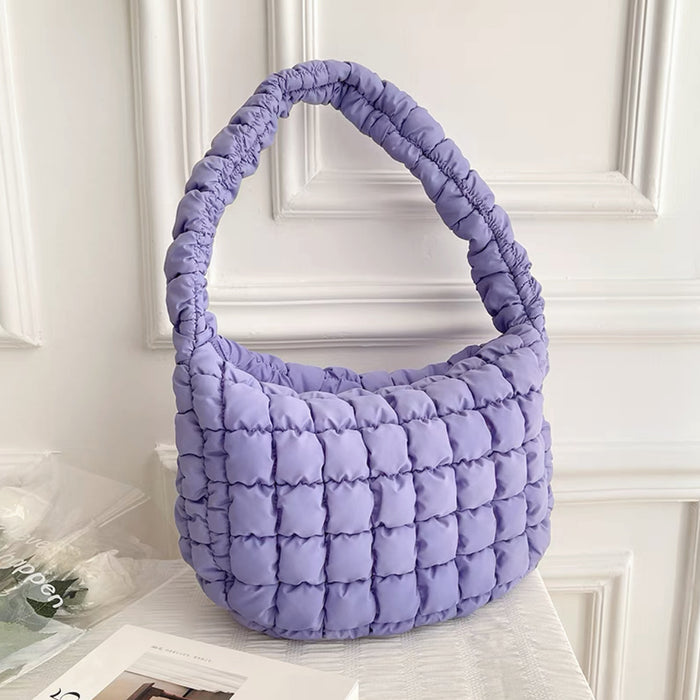 Purple puffy shoulder bag on a white background.