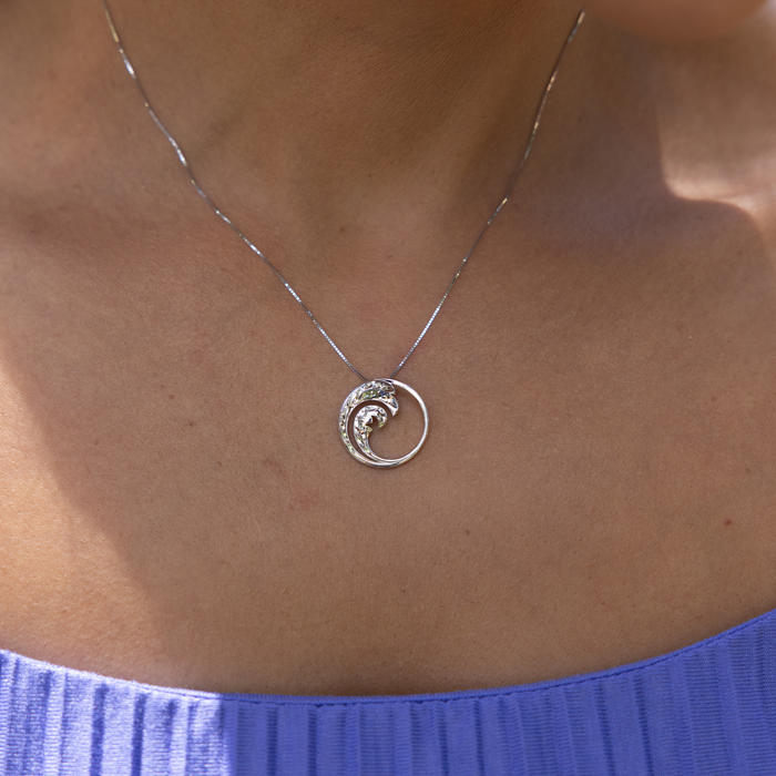 Close up of Nalu Charm/Pendant in Sterling Silver on a woman's chest