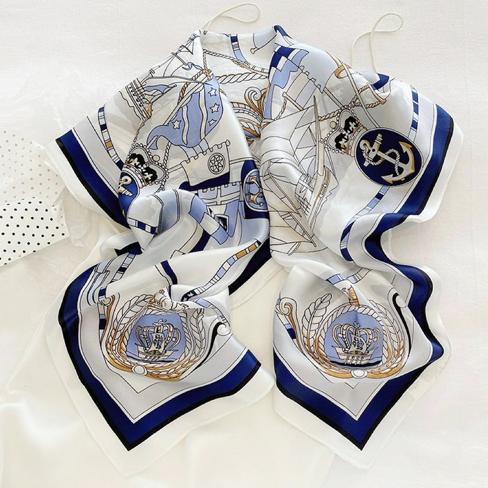 Front view of White satin square scarf with blue nautical chart, anchor, and crown designs in navy, great for office.