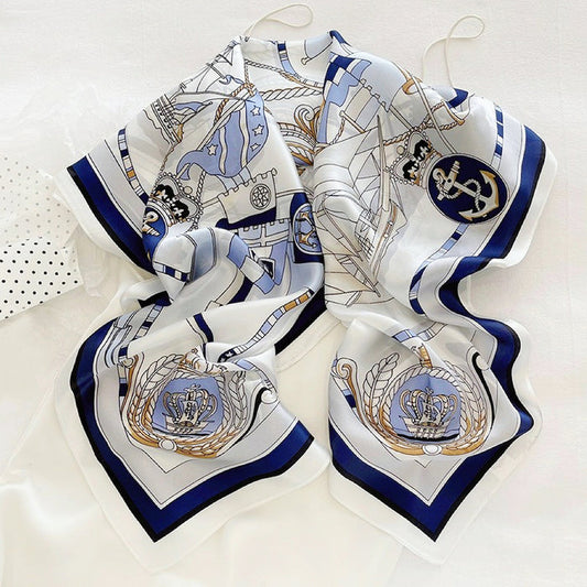 Front view of White satin square scarf with blue nautical chart, anchor, and crown designs in navy, great for office.