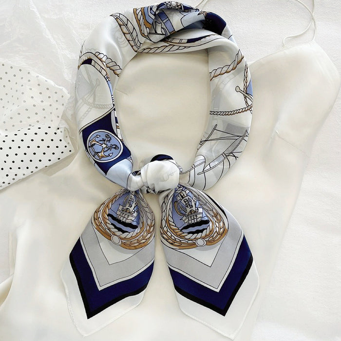 Front view of a tied satin scarf in navy,  elegant accessory styling for handbags.