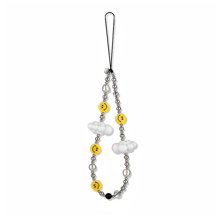 Front view of phone charm with yellow smiley faces, white cloud beads, and clear beads on a black cord.