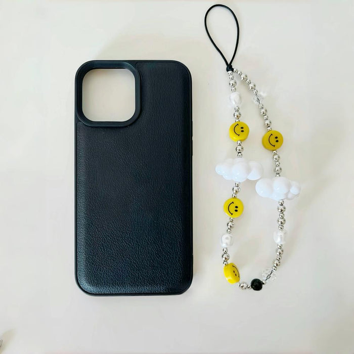 Nice Day Phone Charm beside a black phone case, ideal for travel and daily use.