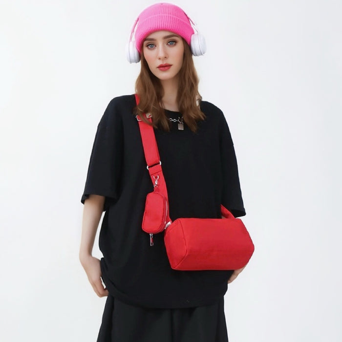 Model carrying a red nylon crossbody bag , easy for commuting and weekends.