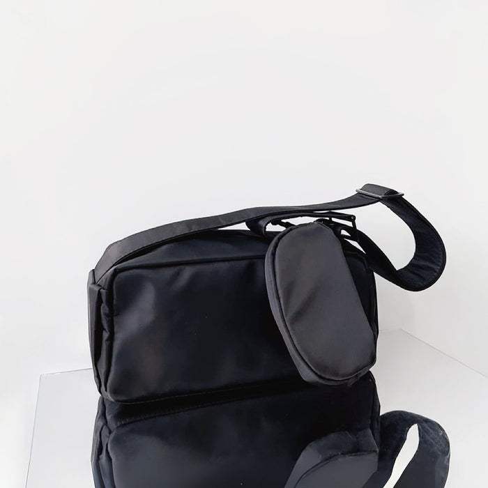 Flat lay of Nylon Brick Cassette Crossbody Bag in black, great for everyday carry and travel.