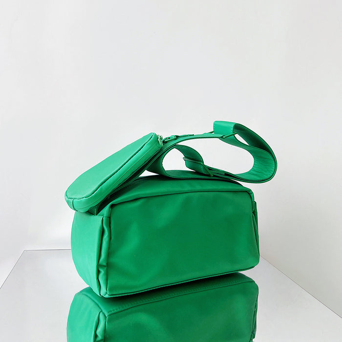 Folded view of Nylon Brick Cassette Crossbody Bag in green, easy for commuting and weekends.