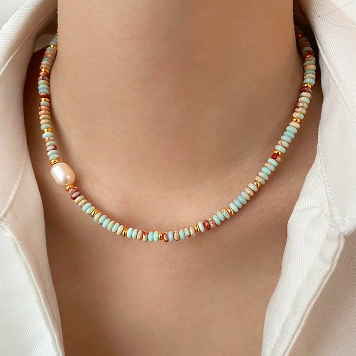 Model wearing an Ocean Breeze Necklace in Aqua Beads, great for everyday outfits.