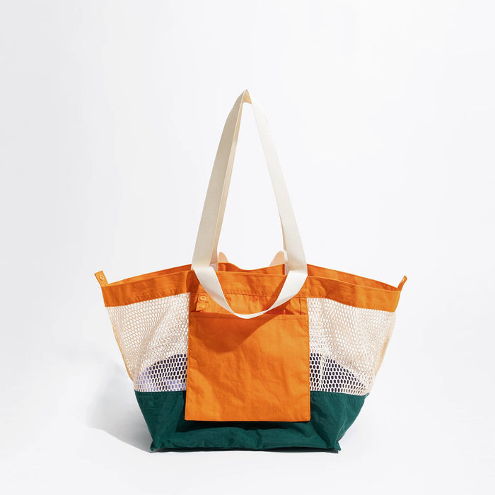 Detailed front view of the vibrant orange and green double-sided tote bag.