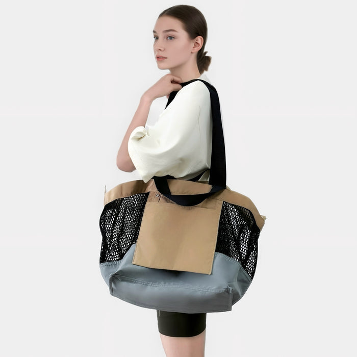 Model wearing the khaki and black double-sided tote bag as a shoulder bag.