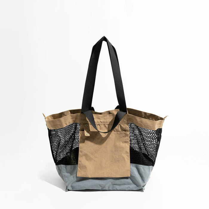 Front view of the versatile khaki and black reversible nylon tote.