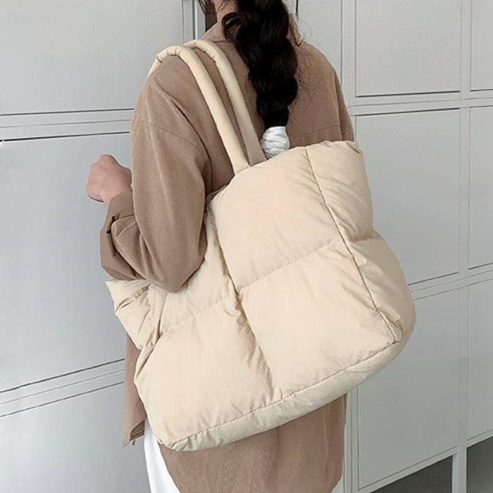 Back view of the apricot padded tote bag worn on the shoulder.