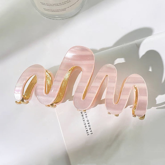 Close-up of Painted Wave Hair Claw  in pink, easy for workdays and special occasions.