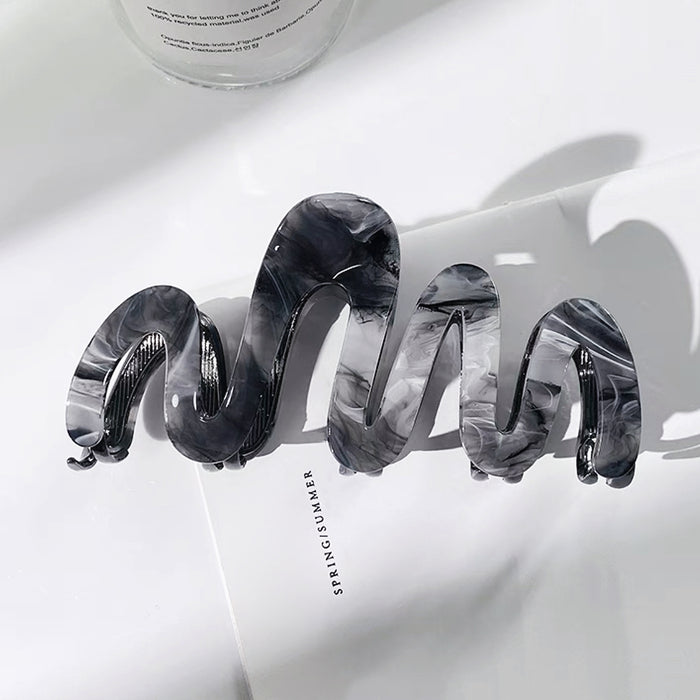 Folded view of Painted Wave Hair Clawn in black, ideal for quick updos and ponytails.