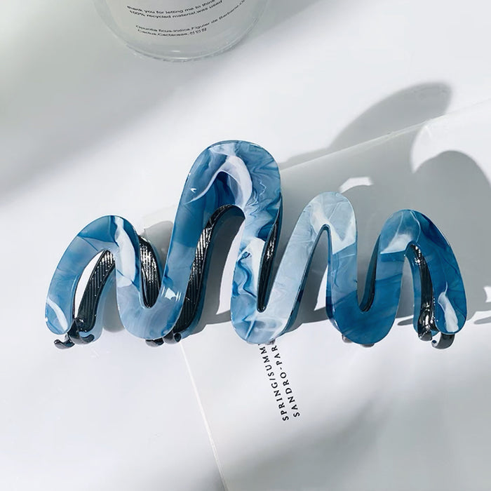 Front view of Painted Wave Hair Claw  in blue, easy for workdays and special occasions.