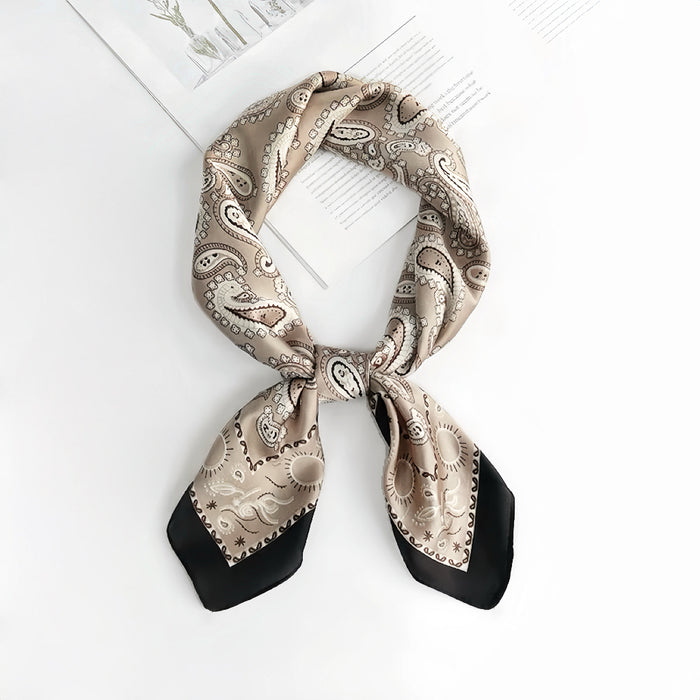 Light khaki paisley scarf folded neatly ideal for professional travel and business meeting accessorizing.
