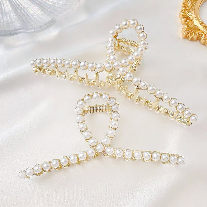Two pearl elegance hair claws in different sizes; high-tension metal hair clips for quiet luxury style.